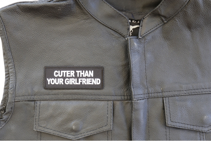 Cuter Than Your Girlfriend Patch - 4x1.5 inch. Embroidered Iron on Patch shown on leather vest