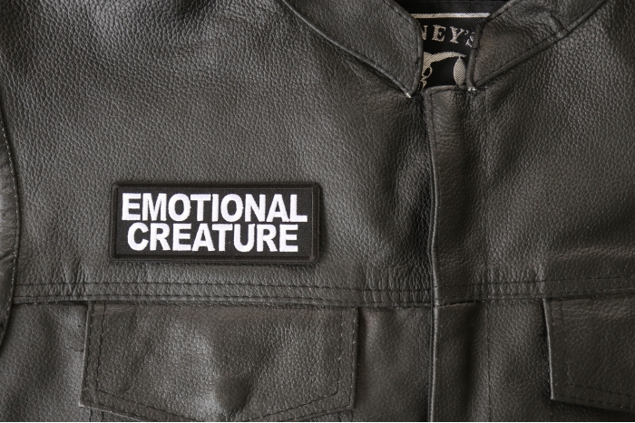 Emotional Creature Patch - 4x1.5 inch - Embroidered Iron on Patch shown on leather vest