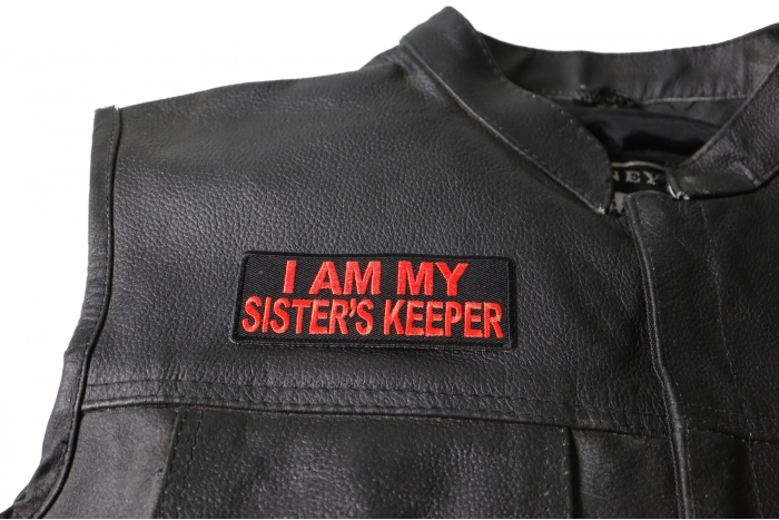 I am My Sister's Keeper Patch in Orange - 4x1.5 inch. Embroidered Iron on Patch shown on leather vest