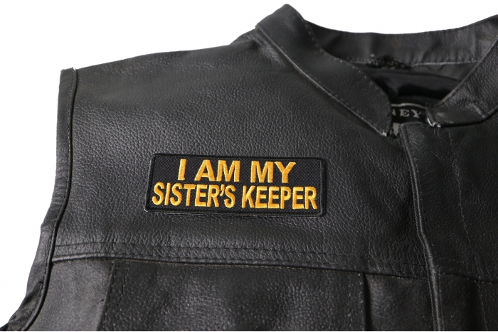 I am My Sister's Keeper Patch in Yellow - 4x1.5 inch. Embroidered Iron on Patch shown on leather vest