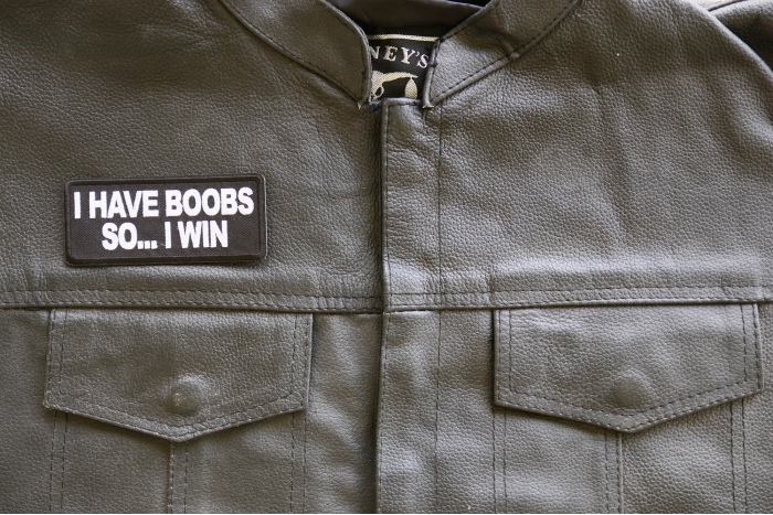 I have Boobs So I Win Iron on Patch shown on leather vest