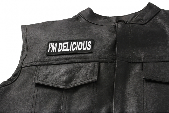 I'm Delicious Patch - 4x1.5 inch. Embroidered Iron on Patch shown on leather vest