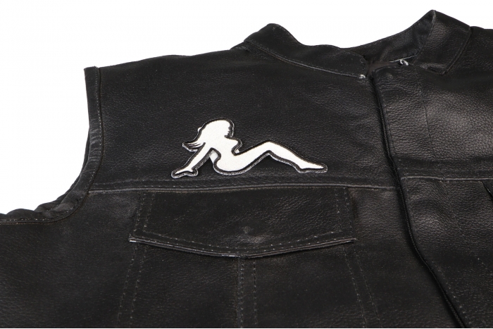 MudFlap Girl Patch In White Facing Right - 4x2 inch. Embroidered Iron on Patch shown on leather vest