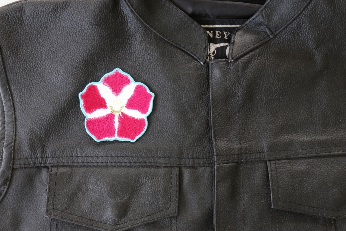 Pink White Flower Patch - 3x3 inch. Embroidered Iron on Patch shown on leather vest