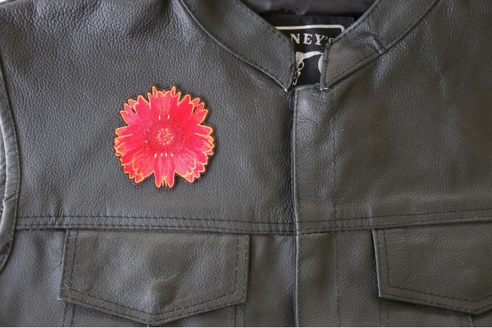 Red Orange Flower Patch - 3x3 inch. Embroidered Iron on Patch shown on leather vest