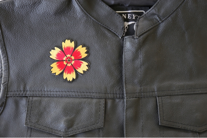 Red Yellow Flower Patch - 3x3 inch. Embroidered Iron on Patch shown on leather vest