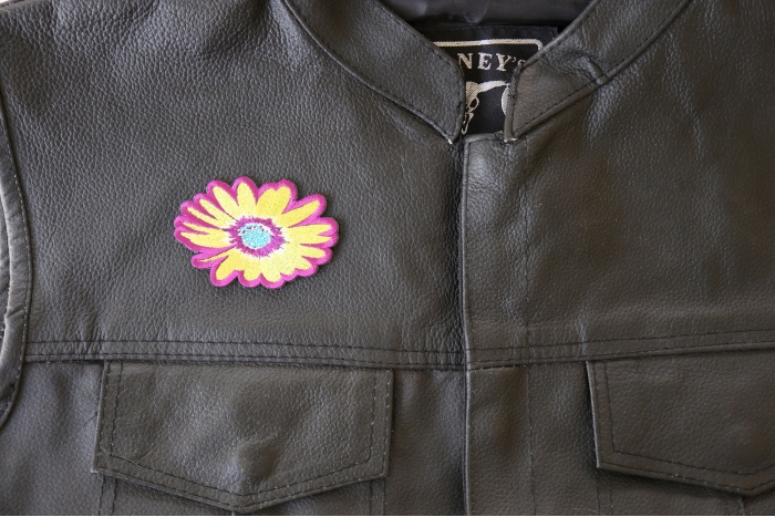 Yellow and Purple Flower Patch - 3x3 inch. Embroidered Iron on Patch shown on leather vest