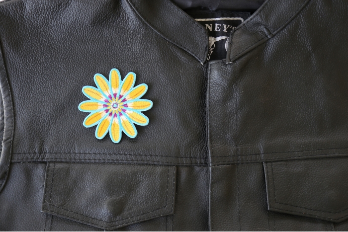 Yellow Blue Flower Patch - 3x3 inch. Embroidered Iron on Patch shown on leather vest