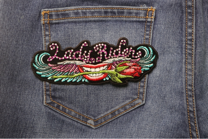 Lips and Roses Lady Rider Embroidered Iron on Patch with Crystals shown on jeans