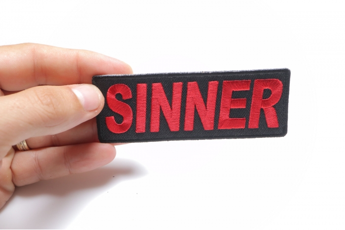 Sinner Patch shown on hand for size comparison