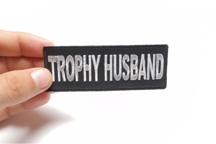 Trophy Husband Patch shown on hand for size comparison