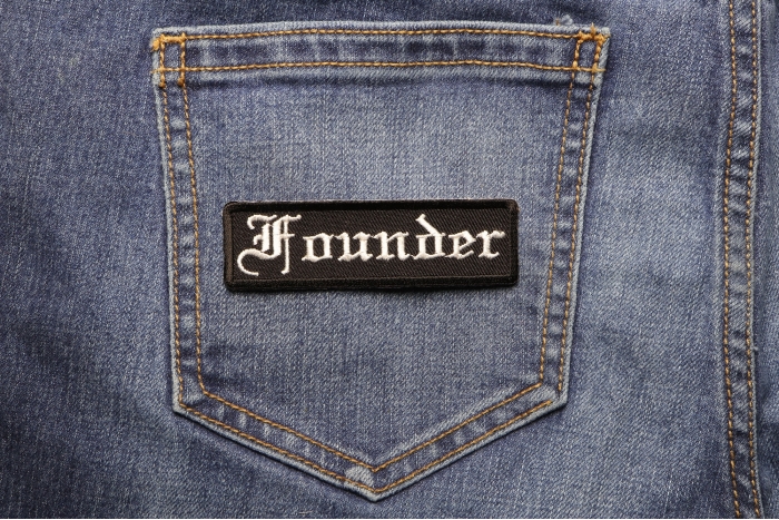 Founder Patch In Old English shown on jeans