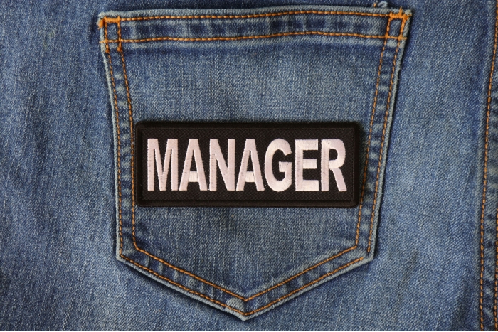 Manager Patch shown on jeans