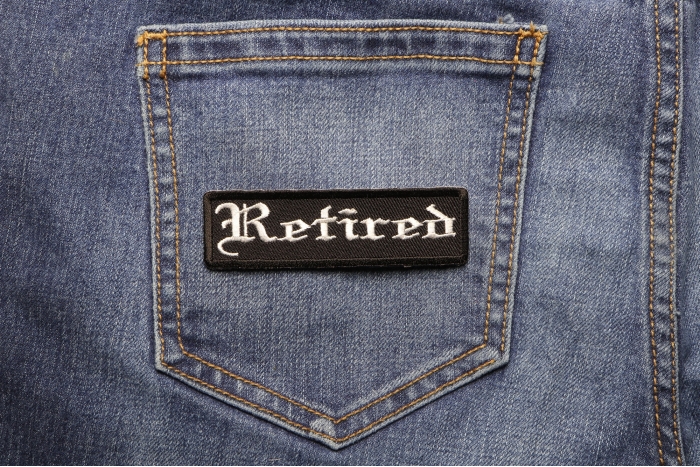 Retired Patch In Old English shown on jeans