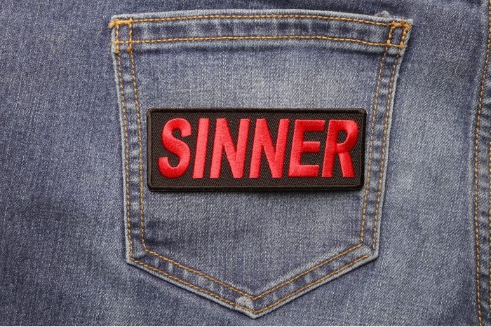 Sinner Patch shown on jeans