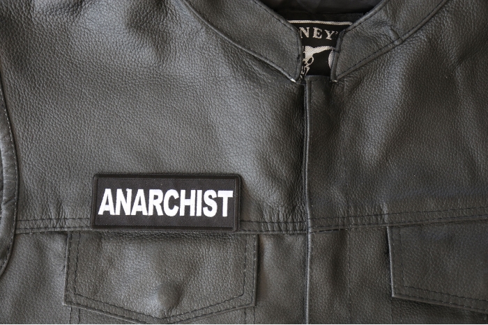 Anarchist Patch - 4x1.5 inch - Embroidered Iron on Patch shown on leather vest
