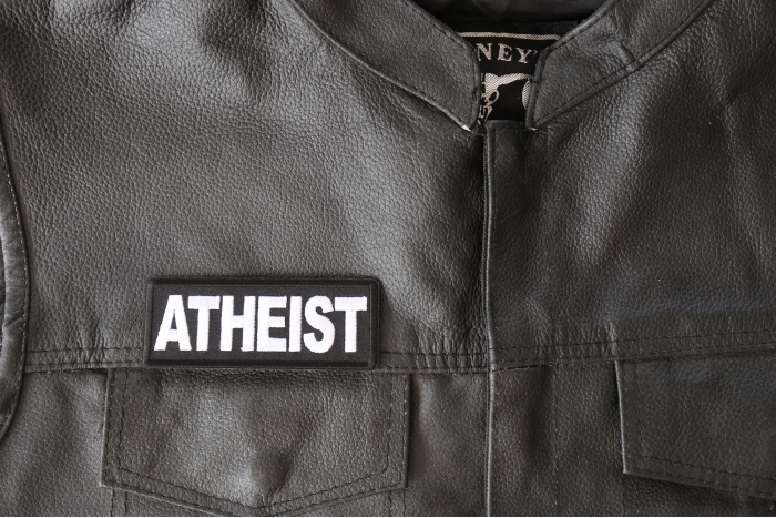 Atheist Patch - 4x1.5 inch - Embroidered Iron on Patch shown on leather vest