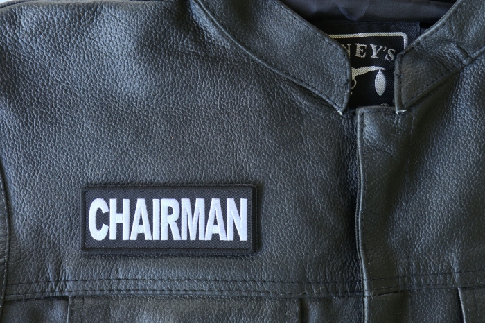 Chairman Patch - 4x1.5 inch - Embroidered Iron on Patch shown on leather vest