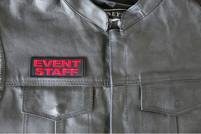 Event Staff Patch Red - 4x1.5 inch - Embroidered Iron on Patch shown on leather vest