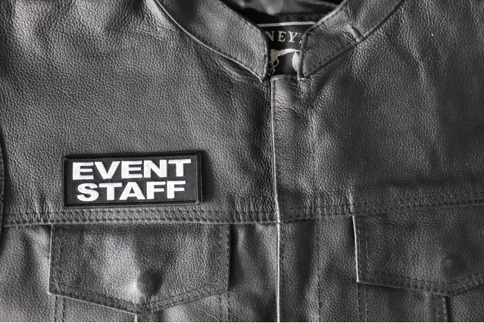 Event Staff Patch White - 4x1.5 inch - Embroidered Iron on Patch shown on leather vest
