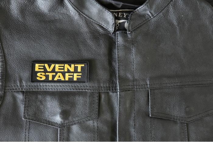 Event Staff Patch Yellow - 4x1.5 inch - Embroidered Iron on Patch shown on leather vest