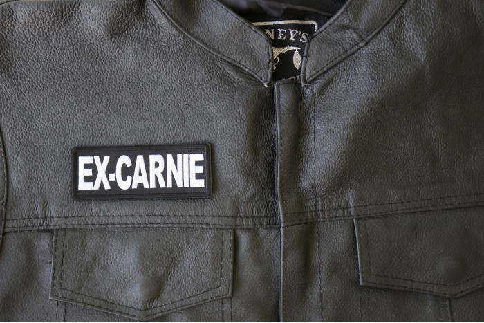 Ex Carnie Patch - 4x1.5 inch - Embroidered Iron on Patch shown on leather vest