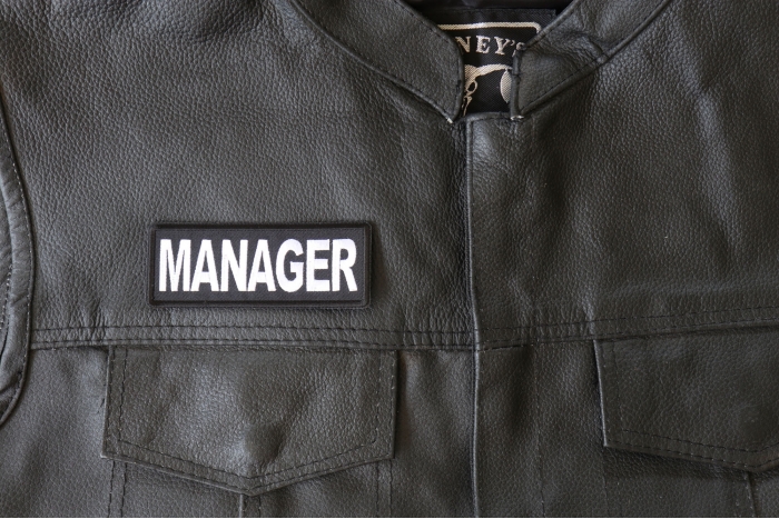 Manager Patch - 4x1.5 inch - Embroidered Iron on Patch shown on leather vest