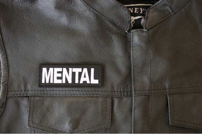 Mental Patch - 4x1.5 inch - Embroidered Iron on Patch shown on leather vest