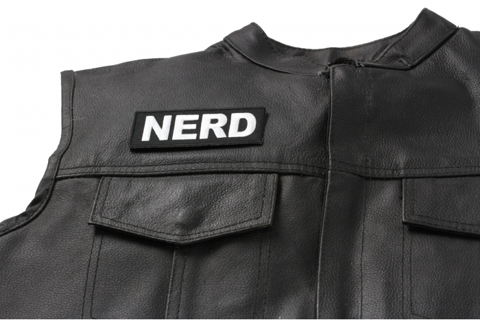 Nerd Patch - 4x1.5 inch. Embroidered Iron on Patch shown on leather vest