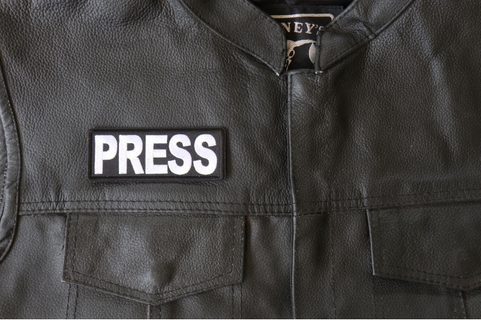 Press Patch - 4x1.5 inch - Embroidered Iron on Patch shown on leather vest