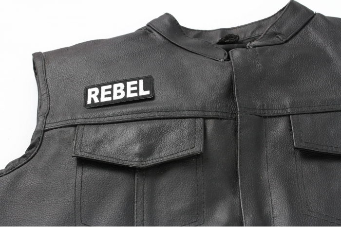 Rebel Patch - 3x1.5 inch. Embroidered Iron on Patch shown on leather vest