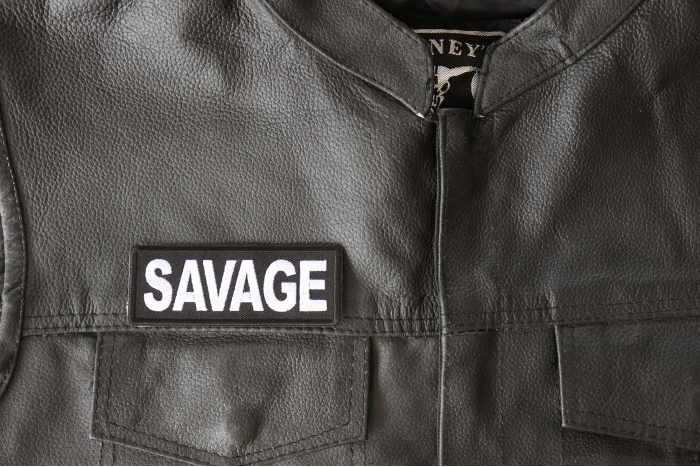 Savage Patch - 4x1.5 inch - Embroidered Iron on Patch shown on leather vest