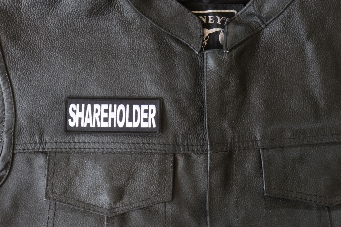 Shareholder Patch - 4x1.5 inch - Embroidered Iron on Patch shown on leather vest