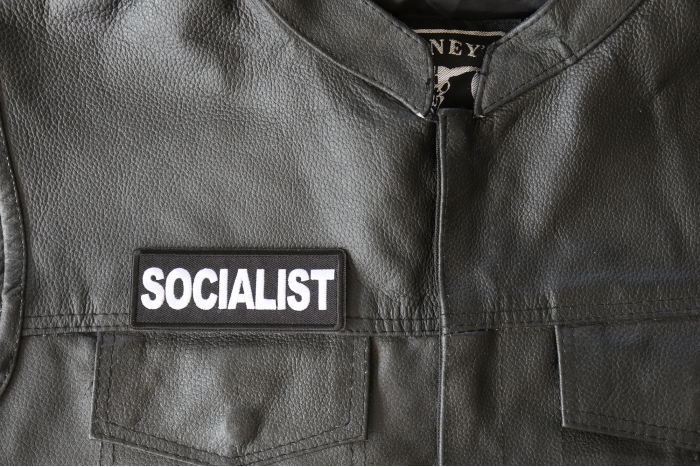 Socialist Patch - 4x1.5 inch - Embroidered Iron on Patch shown on leather vest