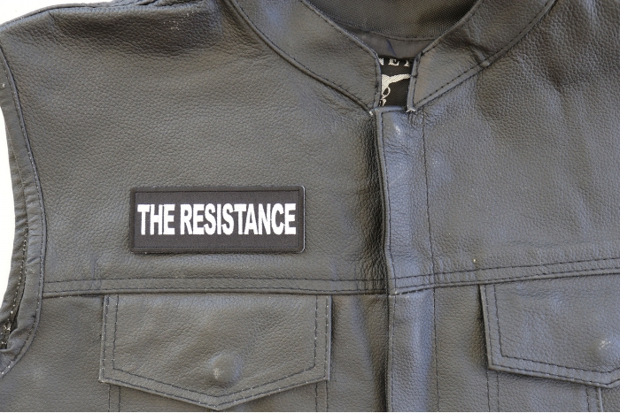 The Resistance Patch - 4x1.5 inch. Embroidered Iron on Patch shown on leather vest