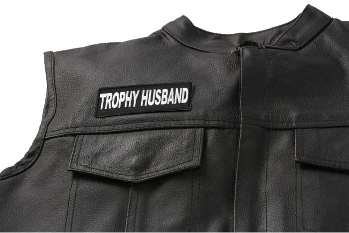 Trophy Husband Patch - 4x1.5 inch. Embroidered Iron on Patch shown on leather vest