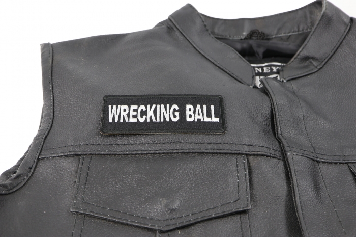 Wrecking Ball Patch - 4x1.5 inch. Embroidered Iron on Patch shown on leather vest
