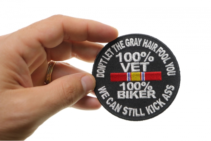 100 Percent Vet 100 Percent Biker We Can Still Kick Ass Patch shown on hand for size comparison