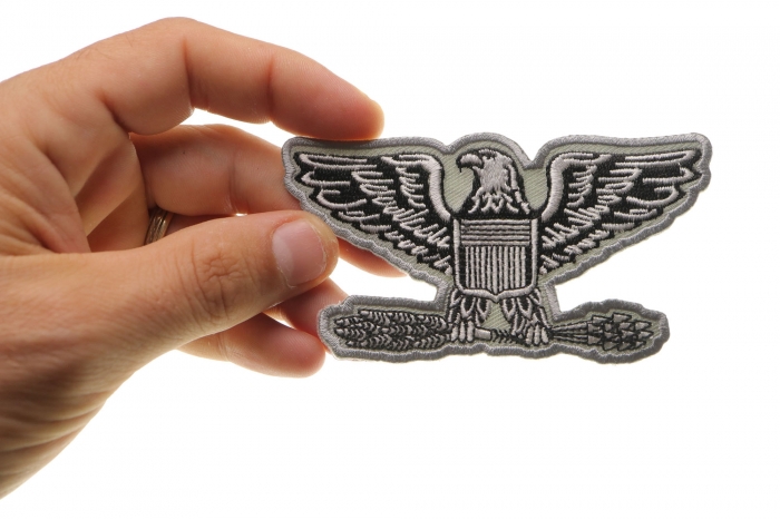 Colonel Eagle Insignia Patch shown on hand for size comparison