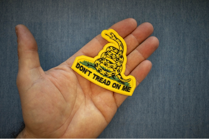 Don't Tread On Me Small Patch shown on hand for size comparison