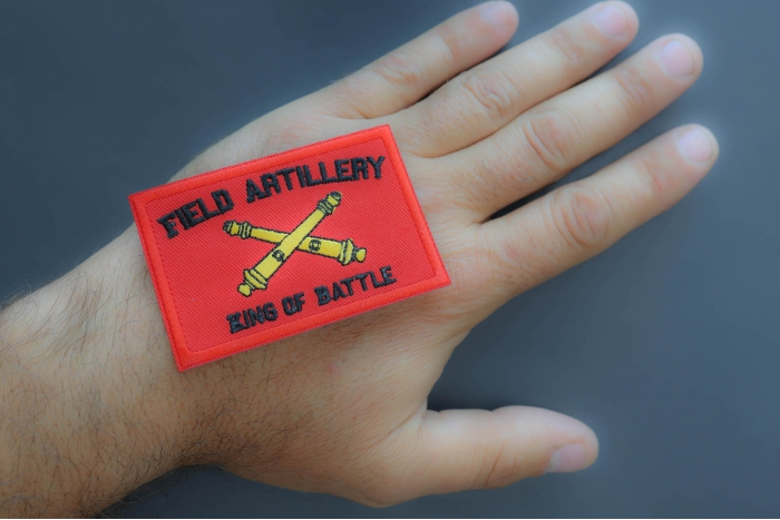 Field Artillery King of Battle Patch shown on hand for size comparison