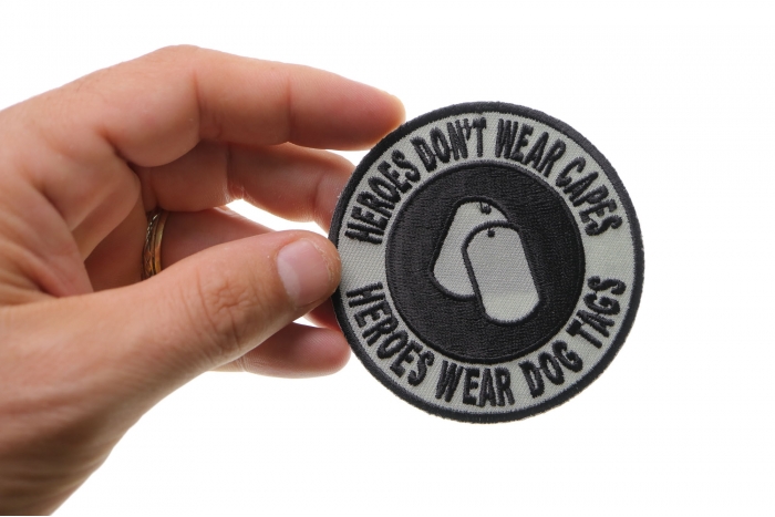 Heroes Don't Wear Capes Round Patch shown on hand for size comparison