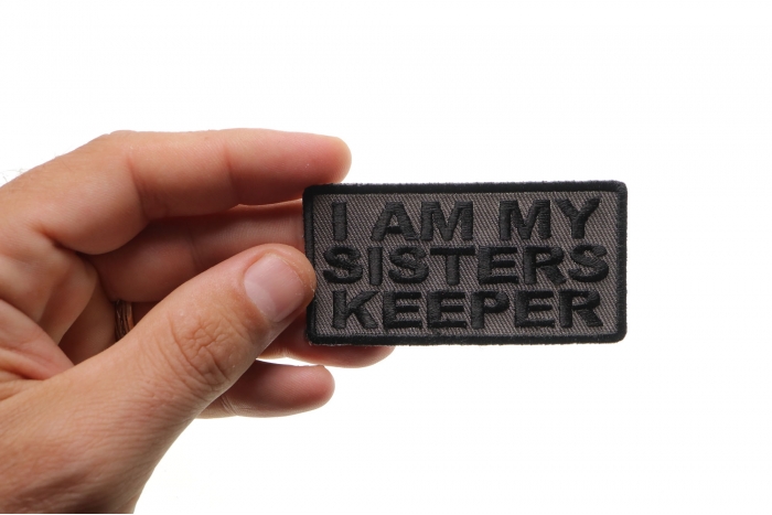 I Am My Sisters Keeper Black Gray Patch shown on hand for size comparison
