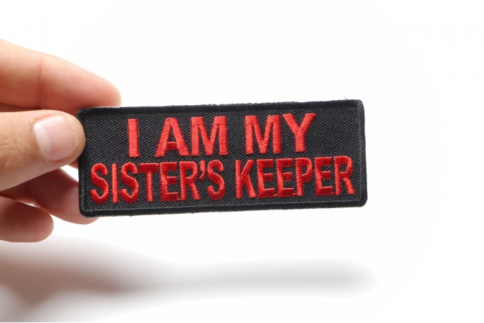 I Am My Sister's Keeper Patch In Red shown on hand for size comparison