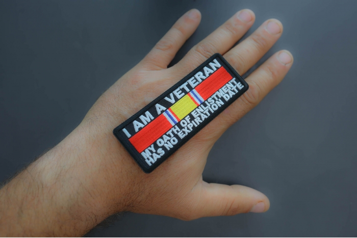 I Am A Veteran My Oath Of Enlistment Has No Expiration Date Patch with National Defense Ribbon, Military Vet Patches shown on hand for size comparison