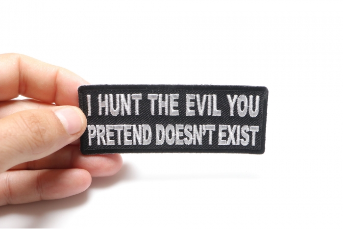 I Hunt the Evil You Pretend Doesn't Exist Military Morale Patch shown on hand for size comparison