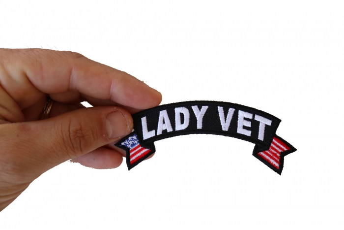 Lady Vet Small Flag Rocker Patch shown on hand for size comparison