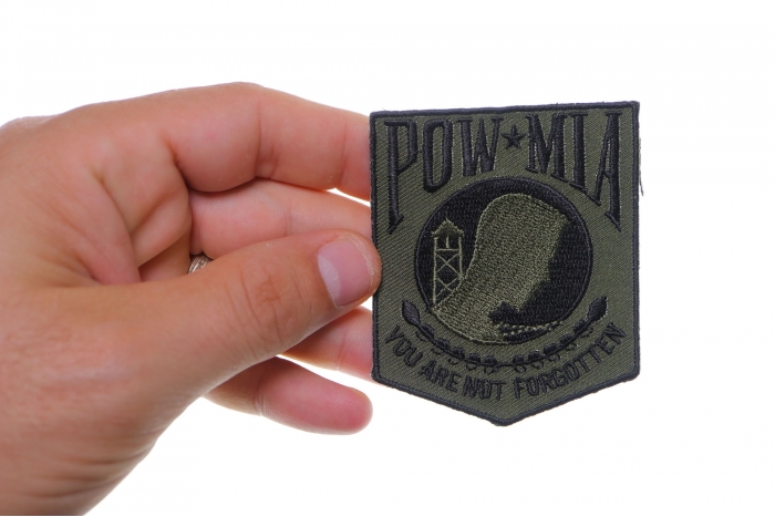 POW MIA Subdued Green Patch shown on hand for size comparison