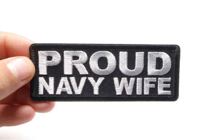 Proud Navy Wife Patch shown on hand for size comparison