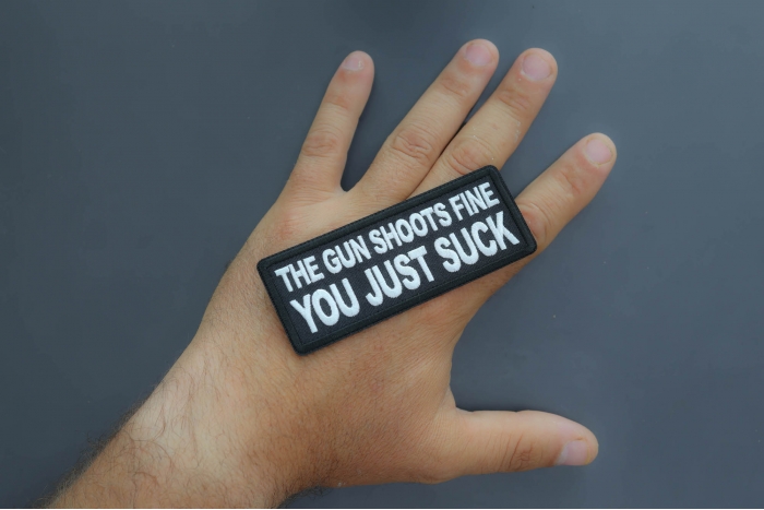 The Gun Shoots Fine You just Suck Patch shown on hand for size comparison
